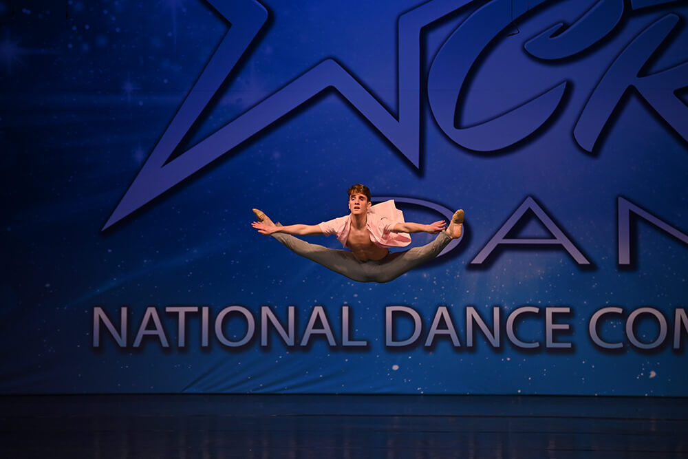 Young dancer performs on stage at CRU Dance Nationals