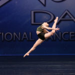 Dancer leaping across stage
