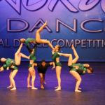 Young dance team wearing green